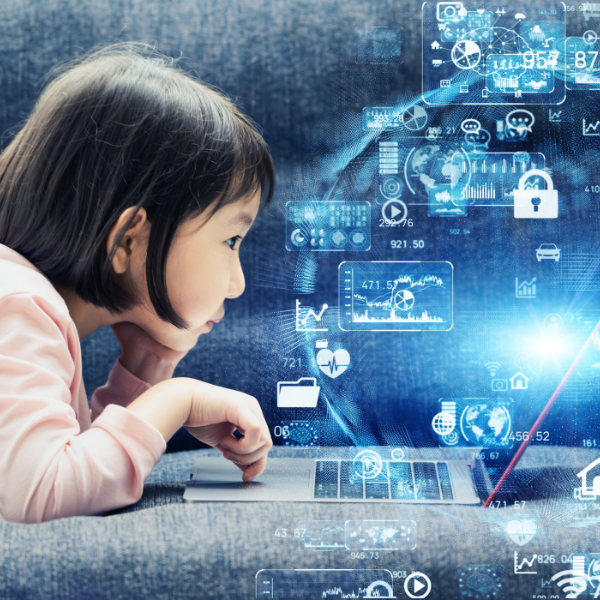 A young girl looks at a laptop screen and logos of technological applications are floating around her